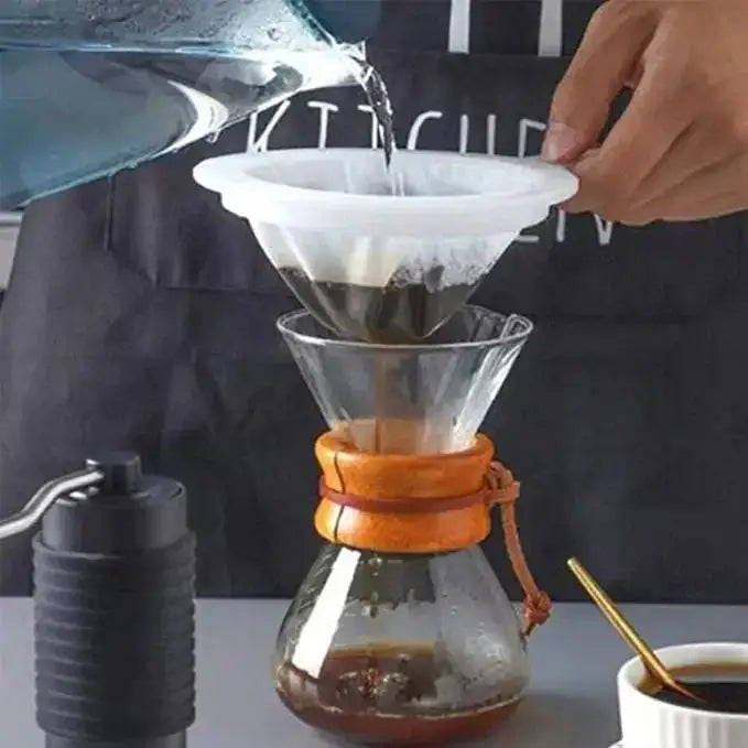 Pouring water through an Ultra Fine Nylon Filter Mesh Strainer into a coffee carafe for brewing.
