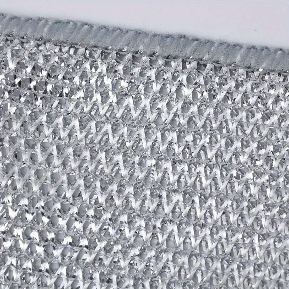 Close-up of a silver non-stick oil iron dishwashing cloth, showcasing its textured surface and knit fabric design.