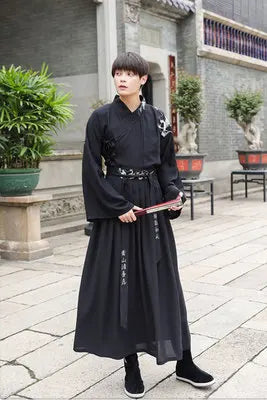 Adult wearing a black Han Dynasty couple costume, featuring a swordsman outfit, in a traditional setting.