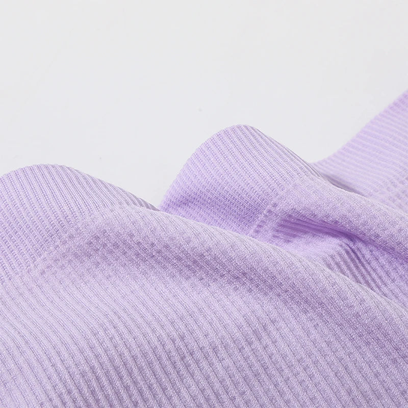 Close-up of soft lavender ribbed fabric for DeepVibe™ seamless crop top, showcasing texture and quality.