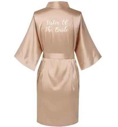 Back view of a rose gold satin robe with 'Sister Of The Bride' text, perfect for bridal parties and special occasions.