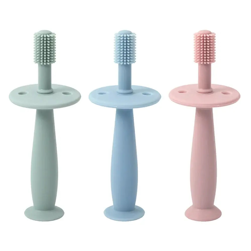Set of 3 soft silicone baby toothbrushes in green, blue, and pink for infants and toddlers training teeth.
