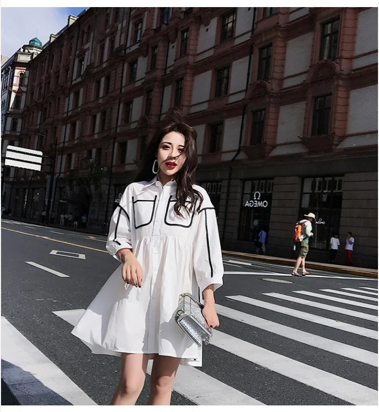 Model wearing a solid color maternity shirt dress with turn-down collar, perfect for summer beach parties.