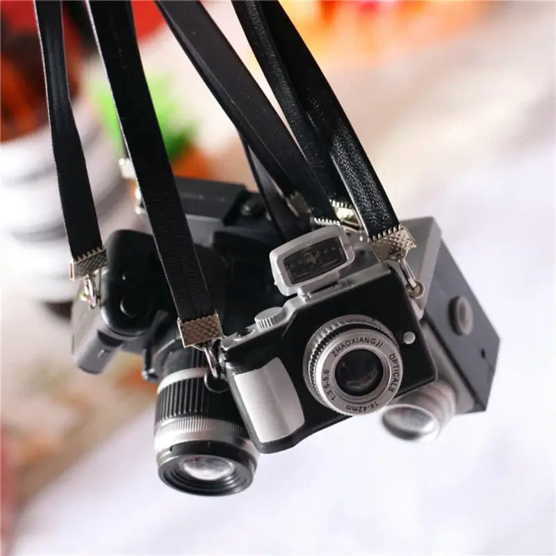 Mini camera for dollhouse, perfect baby photography prop, ideal for ages 0-12 months, unisex design in black.