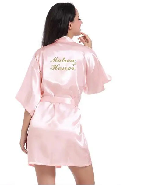 Light pink satin bridesmaid robe with 'Maid of Honor' embroidery, perfect for wedding celebrations.