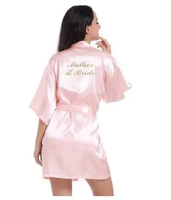 Light pink satin robe for mother of the bride, featuring elegant lettering and short sleeves, perfect for weddings.