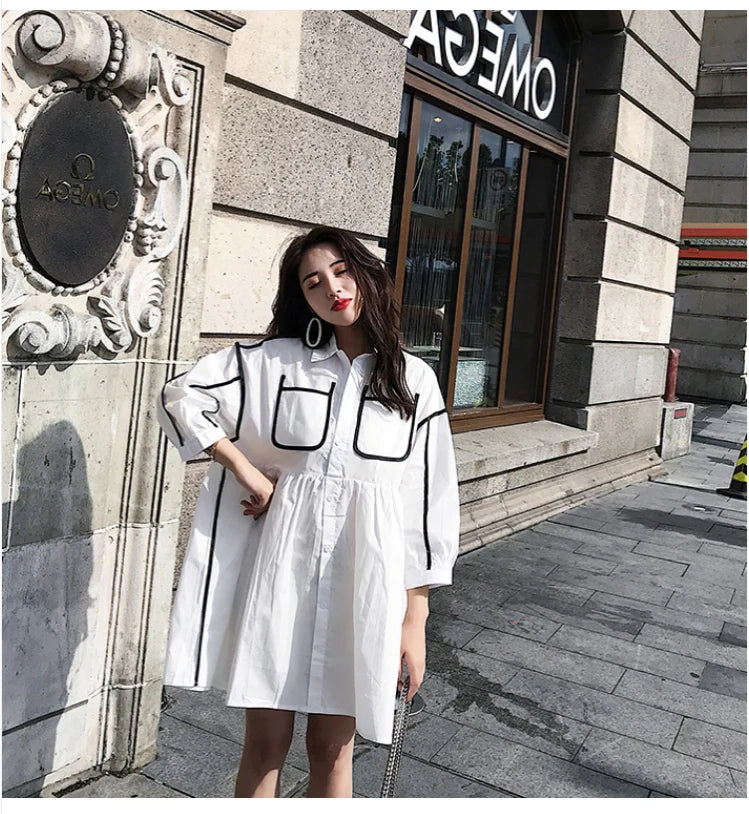 Solid color maternity shirt dress for summer beach parties with pockets and turn-down collar, styled in natural tones.