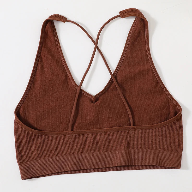 MonoSculpt One-Shoulder Seamless Crop Top in brown, featuring a stylish crisscross back design.