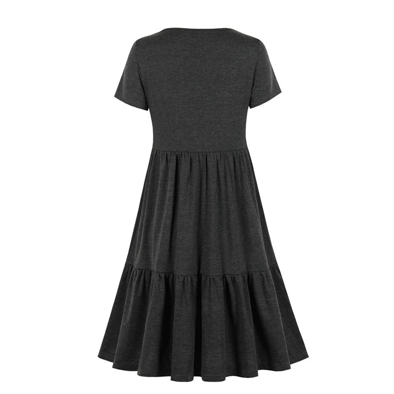 Back view of a sleeveless pleated nursing dress in dark gray, knee length, designed for summer maternity wear.