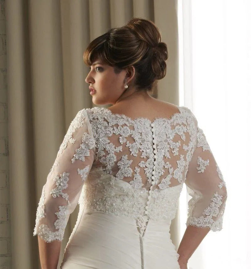 Back view of a bride wearing a crystal beaded wedding jacket with 3/4 sleeves and floral embroidery details.