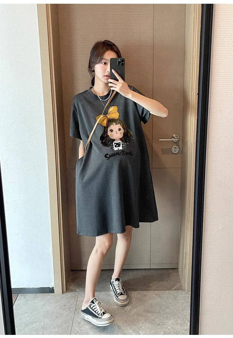 Casual maternity T-shirt dress in dark color with cartoon design, loose fit, ideal for summer wear.
