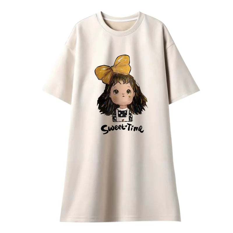 Cream loose maternity t-shirt dress featuring a cartoon girl with a yellow bow and 'Sweet Time' print.
