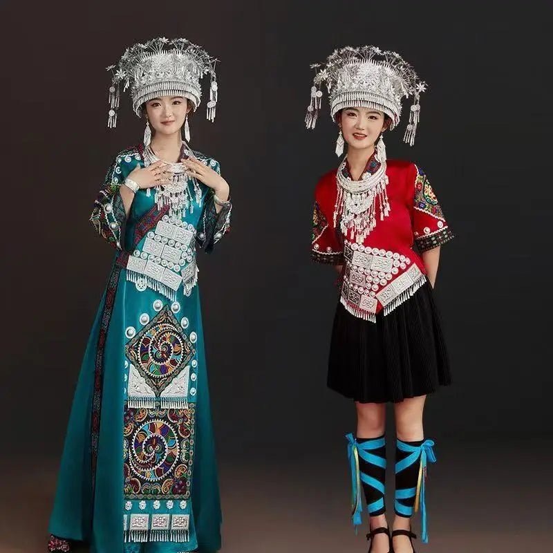 Women in traditional Miao embroidery suits showcasing vibrant festival costumes with intricate silver accessories.