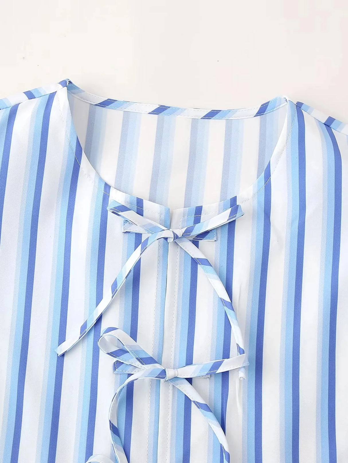 Detail of BowChic™ Stripe Lace-Up Blouse, featuring blue and white stripes and a lace closure.