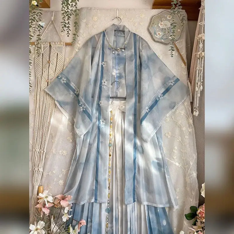 Vintage blue Hanfu three-piece cosplay dress set featuring a sheer kimono-style top and flowing skirt.