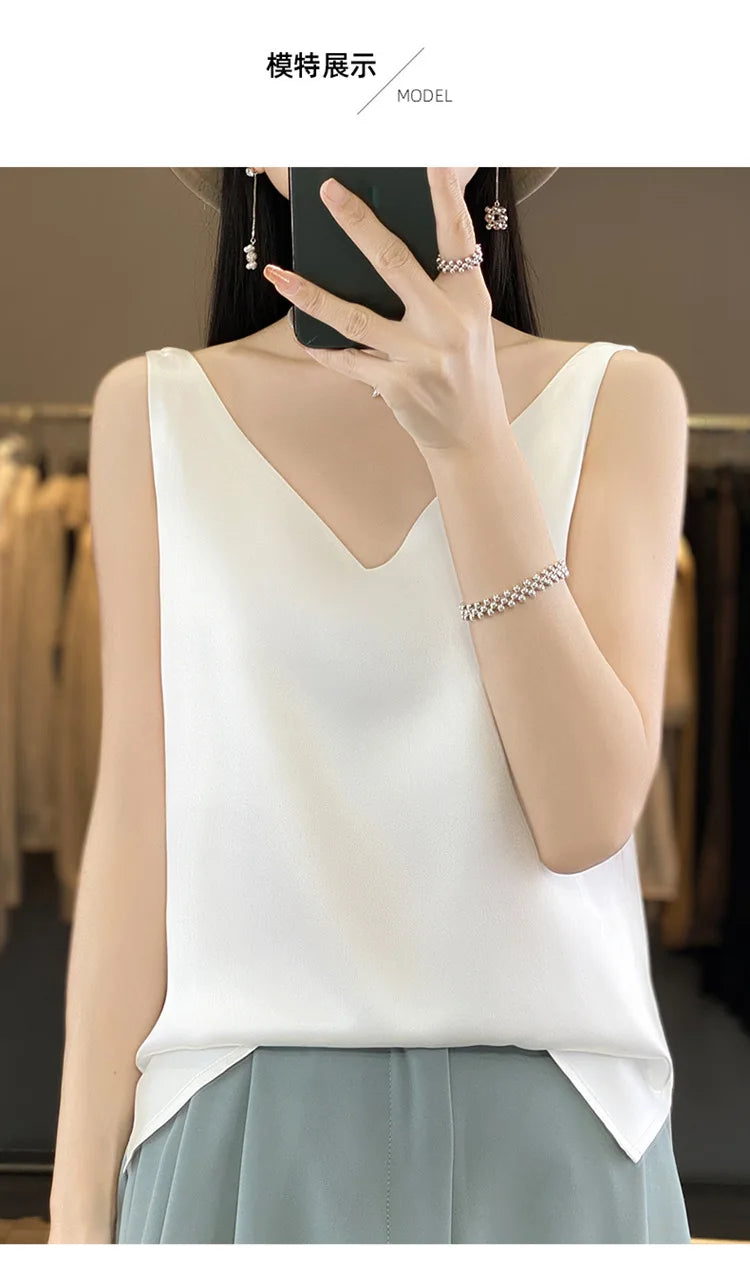 Model wearing a white satin V-neck camisole top, perfect for summer and versatile styling.