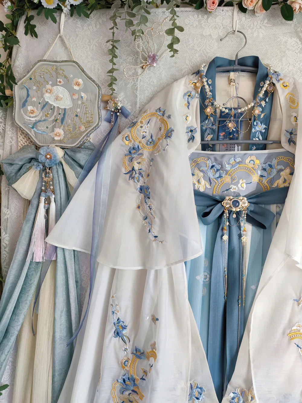 Elegant women's Hanfu costume featuring intricate floral designs in light blue and white for summer parties.