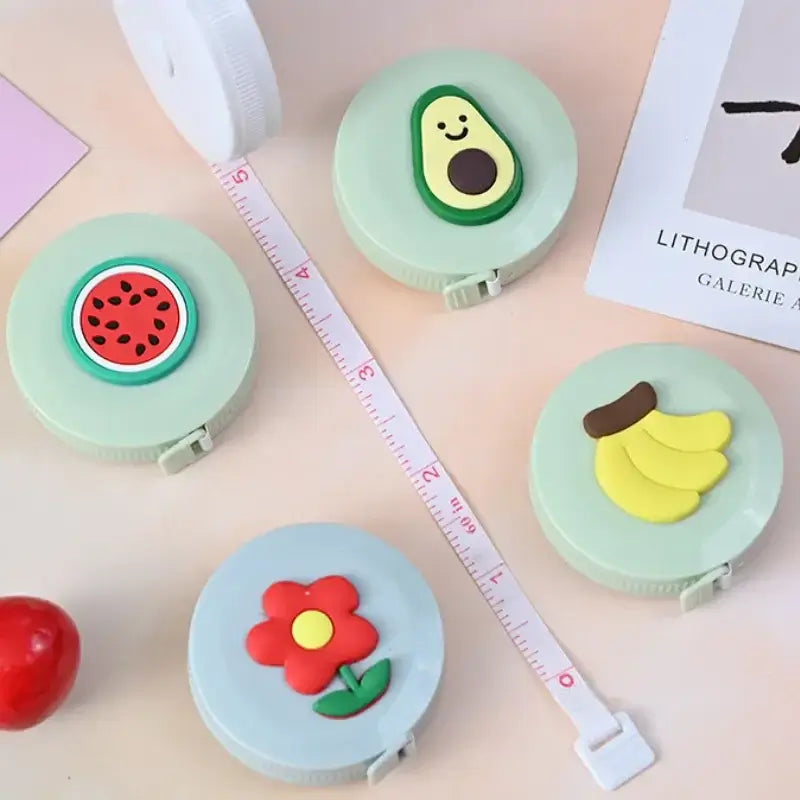 Colorful fruit-themed measuring tape with watermelon, avocado, banana, and flower designs, perfect for kids' use.