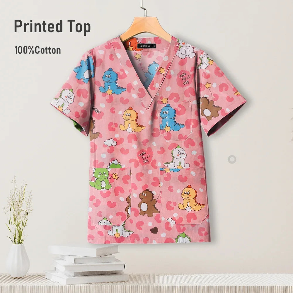 Pediatric nursing uniform scrub top in pink cotton with colorful cartoon animals, perfect for hospitals and beauty salons.