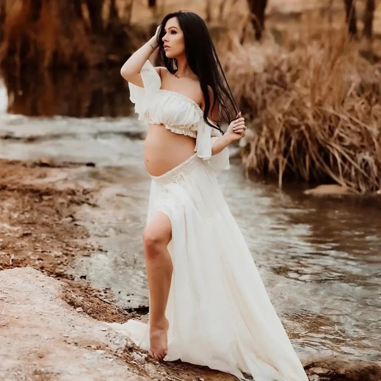 Boho two-piece maternity set shown on a pregnant woman by a serene river, perfect for photoshoots or baby showers.
