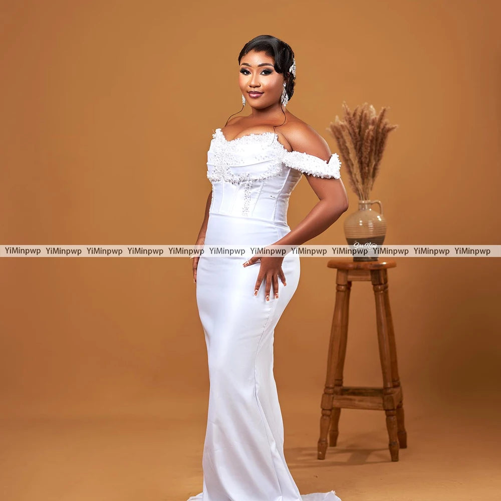 Elegant off-shoulder wedding dress with pearls and detachable train, perfect for brides, available in custom colors.