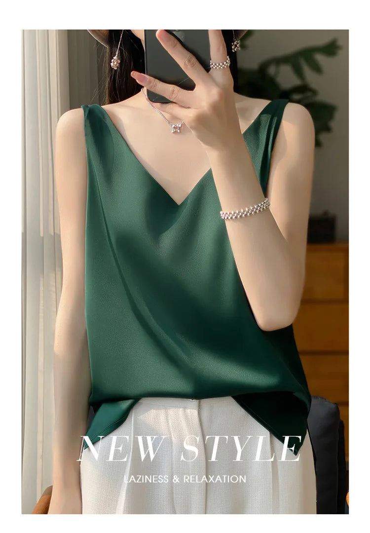 Green satin V-neck tank top worn by a model, perfect for comfort and relaxation in warm weather.
