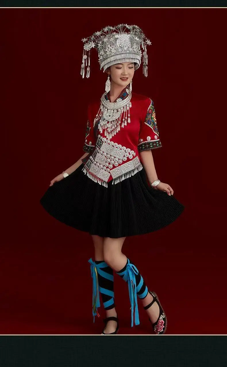 Miao embroidery suit featuring traditional elements, including intricate accessories, worn by a woman during a festival.