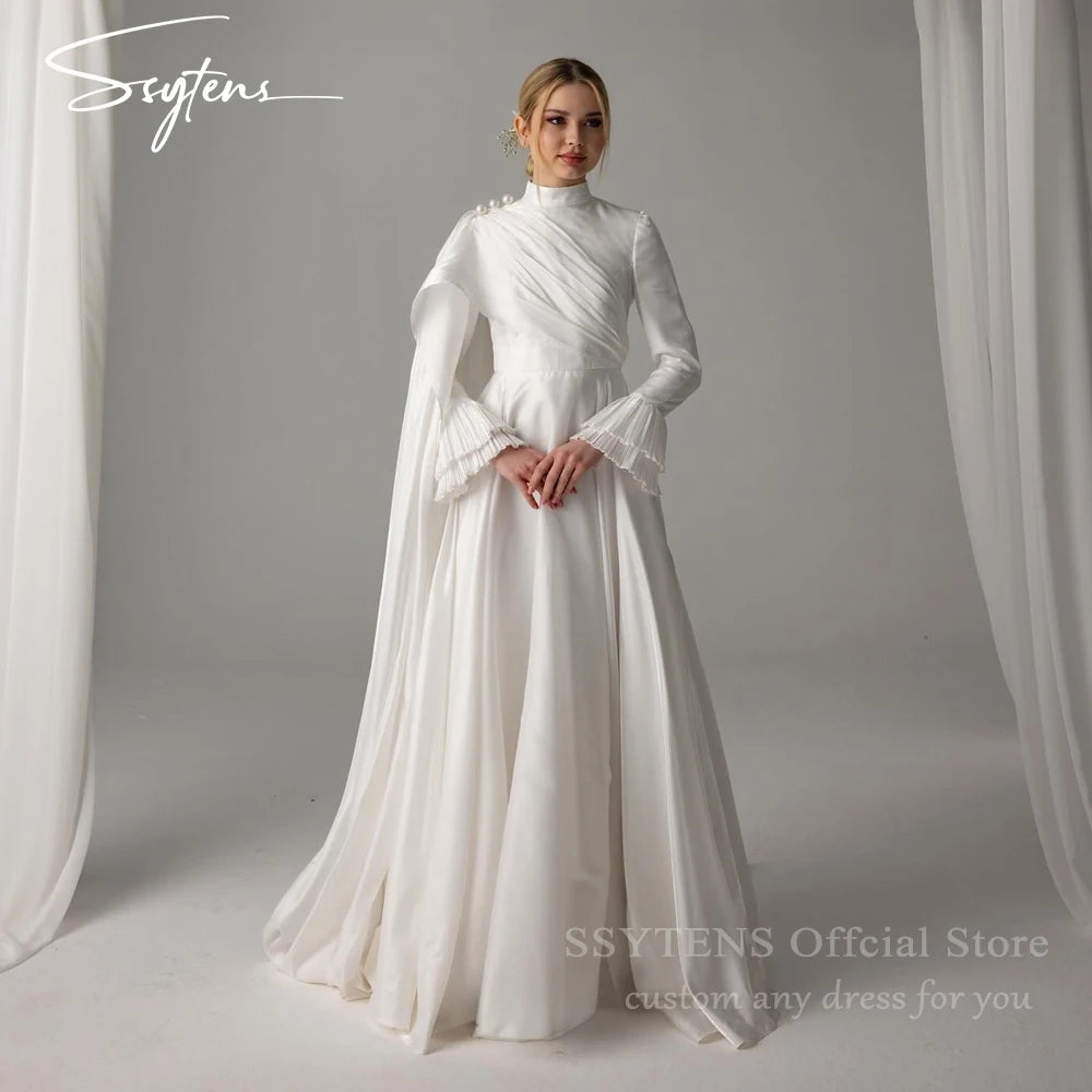 Muslim satin wedding dress with high neck, long sleeves, and pearl embellishments, showcasing a floor-length design.