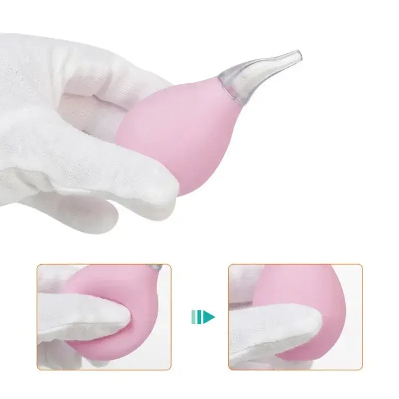 Pink kids nasal aspirator held in a gloved hand, designed for safe nasal care for newborns and infants.