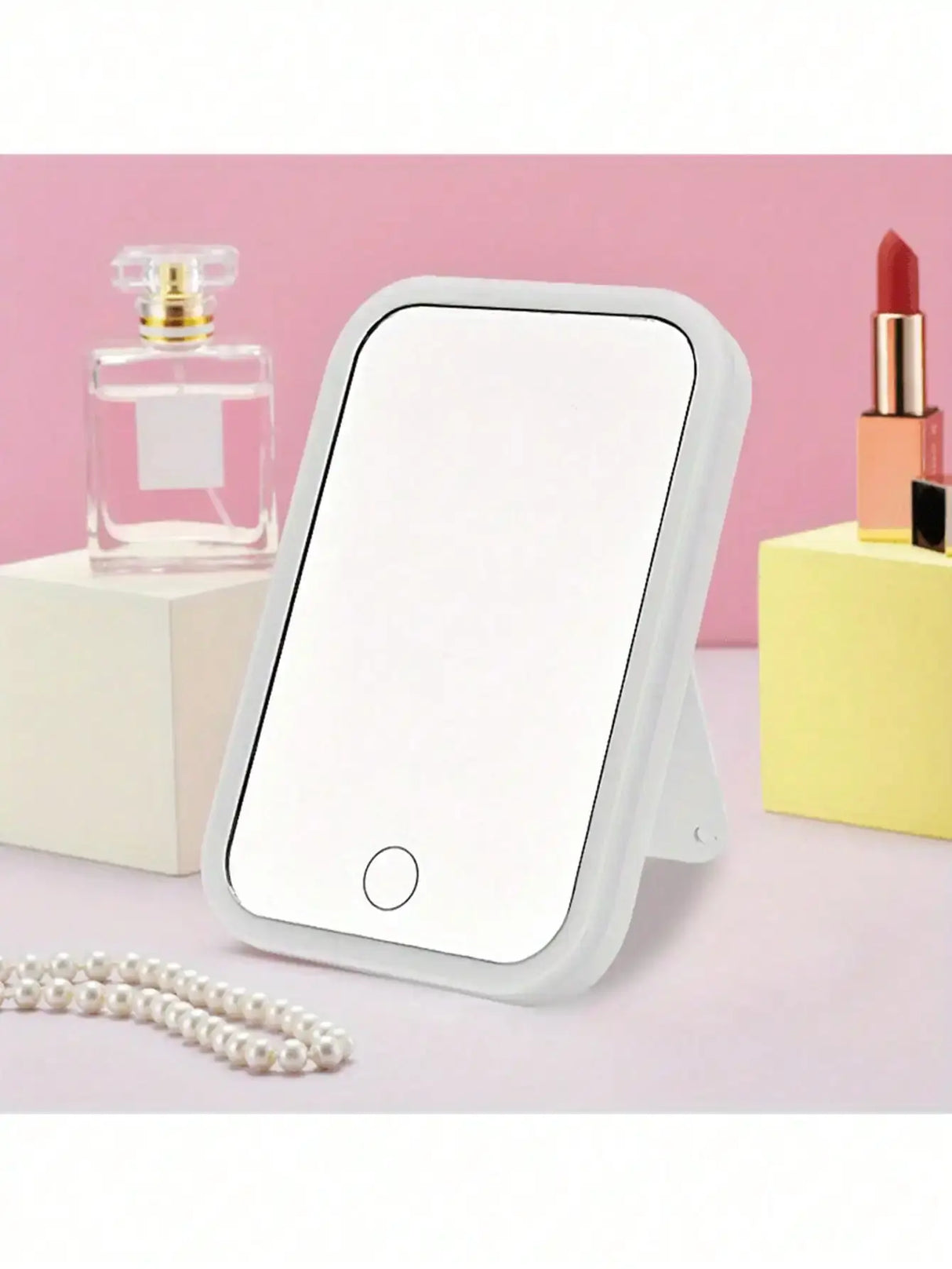 LED makeup mirror with adjustable dimming and storage, featuring a sleek design and set against stylish beauty products.