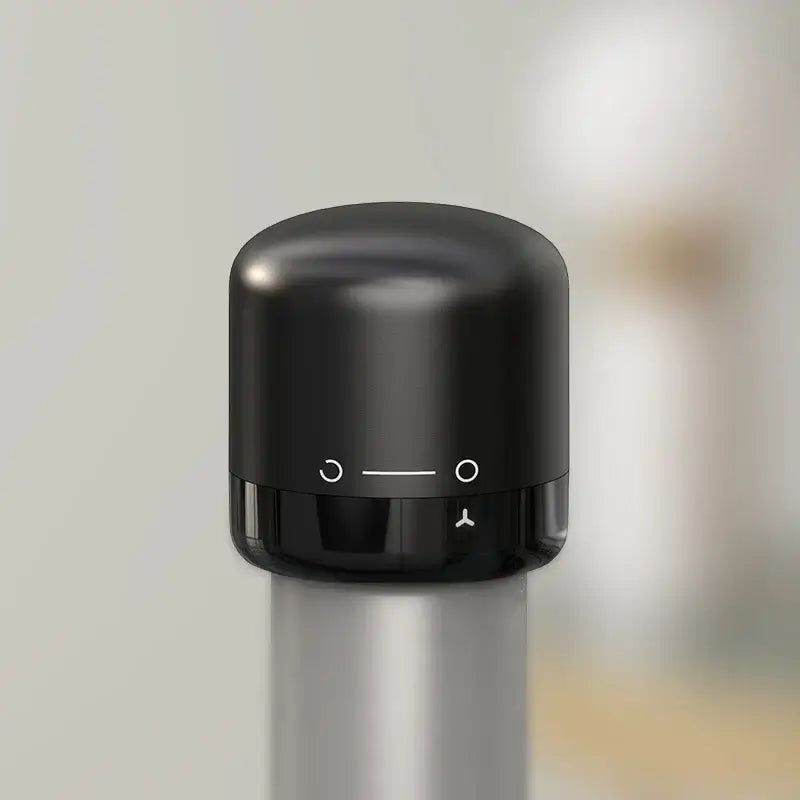 Vacuum red wine bottle cap stopper in sleek black silicone, designed for an airtight seal to preserve wine freshness.