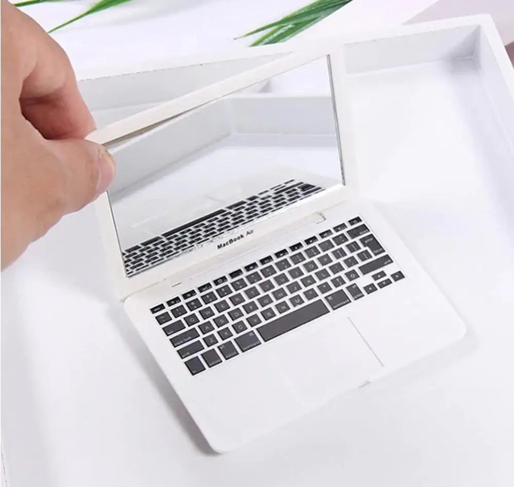 Miniature white laptop with mirror, showcasing detailed keyboard and sleek design, perfect for decorative use.