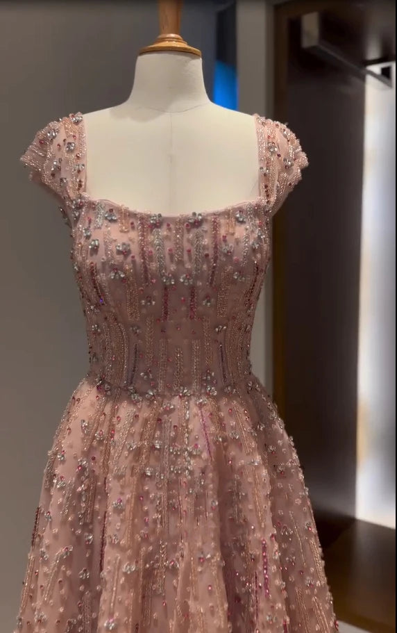 Glitter crystal mermaid wedding gown with square neckline, embellished with beads and sequins, displayed on a mannequin.