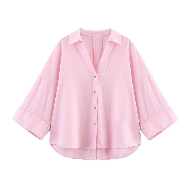 Pink oversized button-up shirt with wide sleeves and a relaxed fit for casual summer wear.