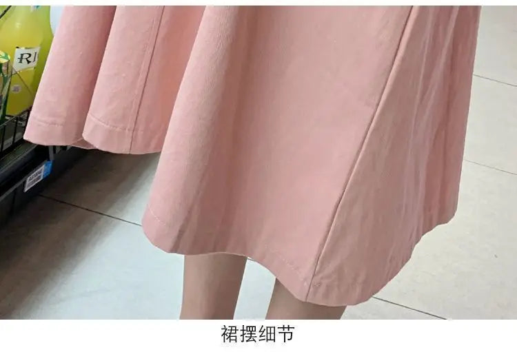 Close-up of the hem of a pink Korean loose fit maternity dress, showcasing its mid-calf length and soft fabric.