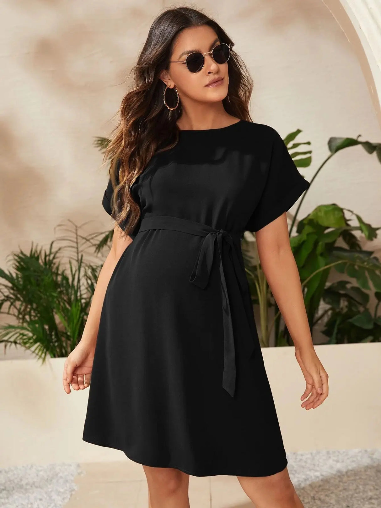 Elegant bat-sleeve maternity tunic dress in black, perfect for summer photoshoots and stylish comfort.