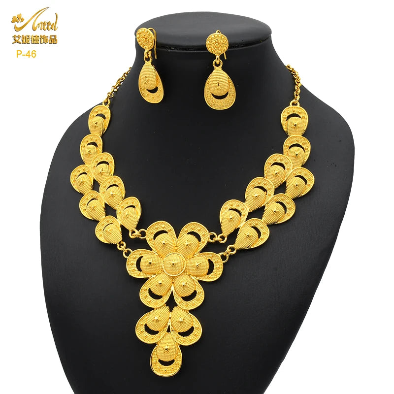 Luxury 24K gold plated Indian bridal jewelry necklace set with matching earrings, perfect for weddings.