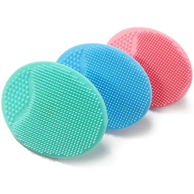 Baby silicone bath brushes in green, blue, and pink, perfect for gentle washing during bath time.