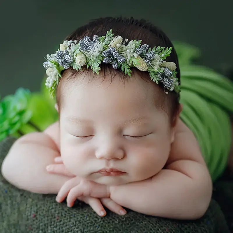 Sweet baby girl in a flower headband, perfect for newborn photography, showcasing adjustable faux flower design.