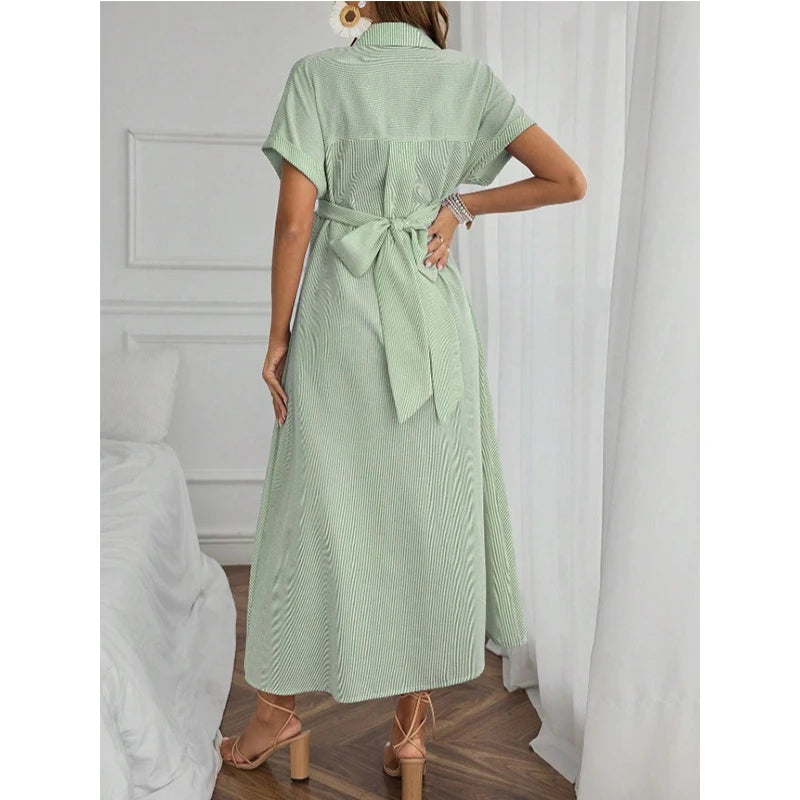 Back view of a woman wearing a striped short sleeve maternity dress in green with a tie waist, perfect for casual summerwear.