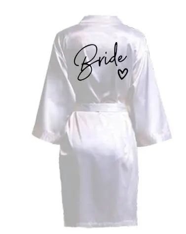 Elegant white satin robe for brides featuring 'Bride' lettering on the back. Perfect for wedding day festivities.