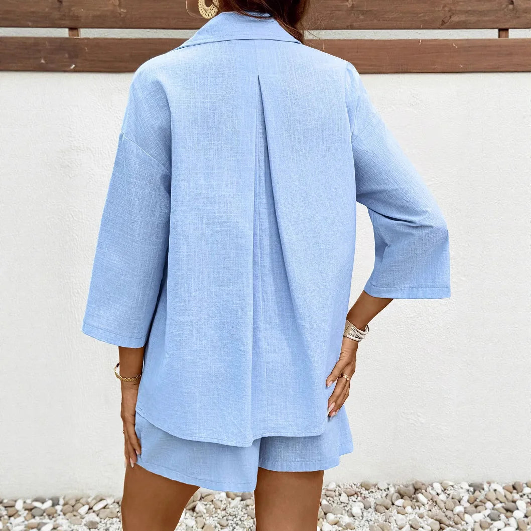Back view of a woman wearing a light blue 2-piece casual maternity set, featuring a shirt and matching shorts.