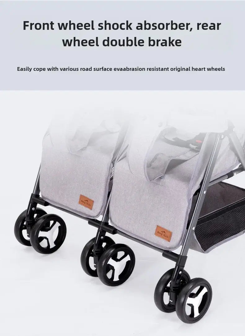 Close-up of a twin baby stroller featuring front wheel shock absorbers and rear wheel double brake for safe navigation.