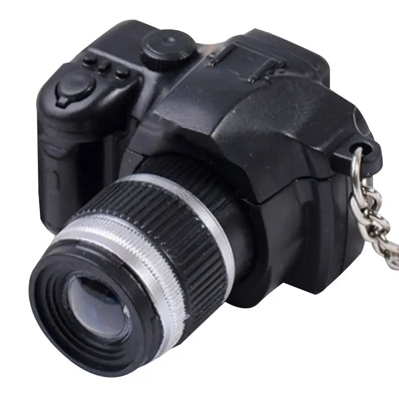 Mini camera for dollhouse, black plastic design, ideal for baby photography props and kids' creative play.