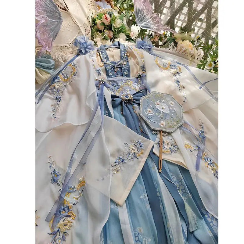 Elegant women's fairy Hanfu costume in blue hues with floral embroidery and matching fan, perfect for summer parties.