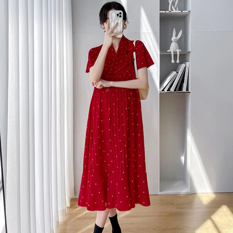 Red polka dot maternity dress with short sleeves and V-neck, perfect for summer wear.