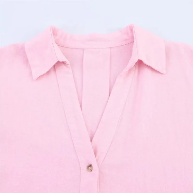 Close-up of a pink AsymLinen™ wide sleeve linen shirt with a turn-down collar and single breasted button closure.