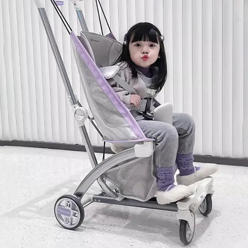 Outdoor lightweight children's stroller with a seated toddler, designed for ages 0-3 years, featuring a foldable travel pram.