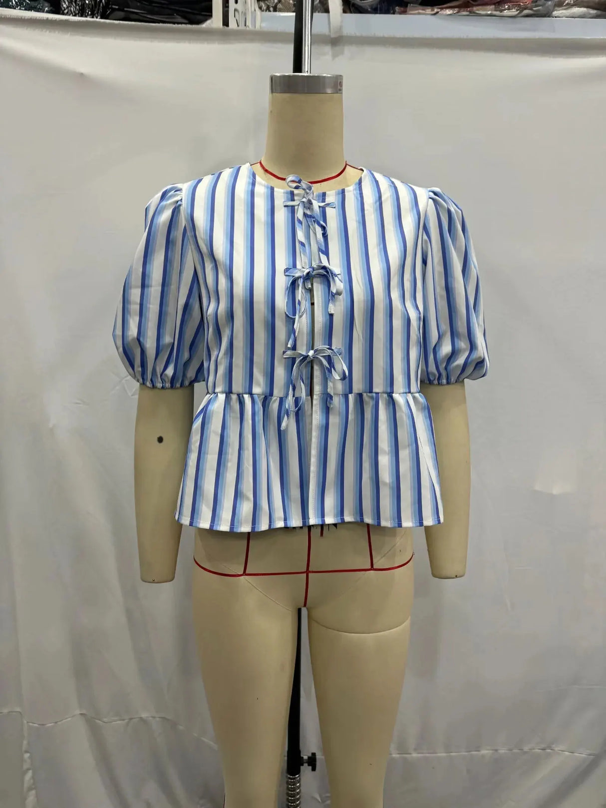Blue and white striped blouse with lace-up detail and short puff sleeves, showcasing TRAFZA vintage style.