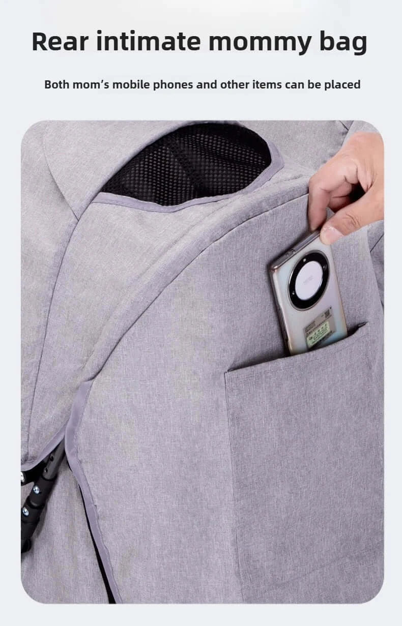 Close-up of rear pocket on a gray mommy bag, showing a smartphone being placed for easy access.